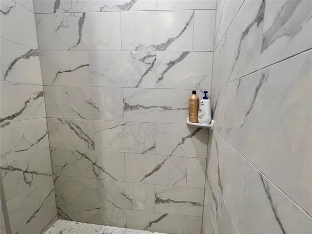 a white toilet sitting next to a shower curtain