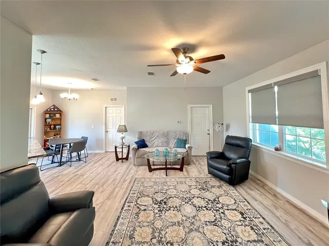 a living room with furniture a fireplace and a large window