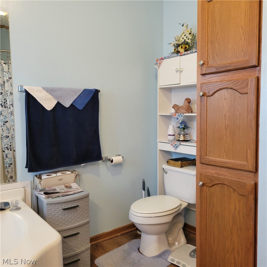 9531 McCormick Road Southwest Newcomerstown, OH 43832 - Photo 3 of 44 Bathroom with toilet and hardwood / wood-style floors