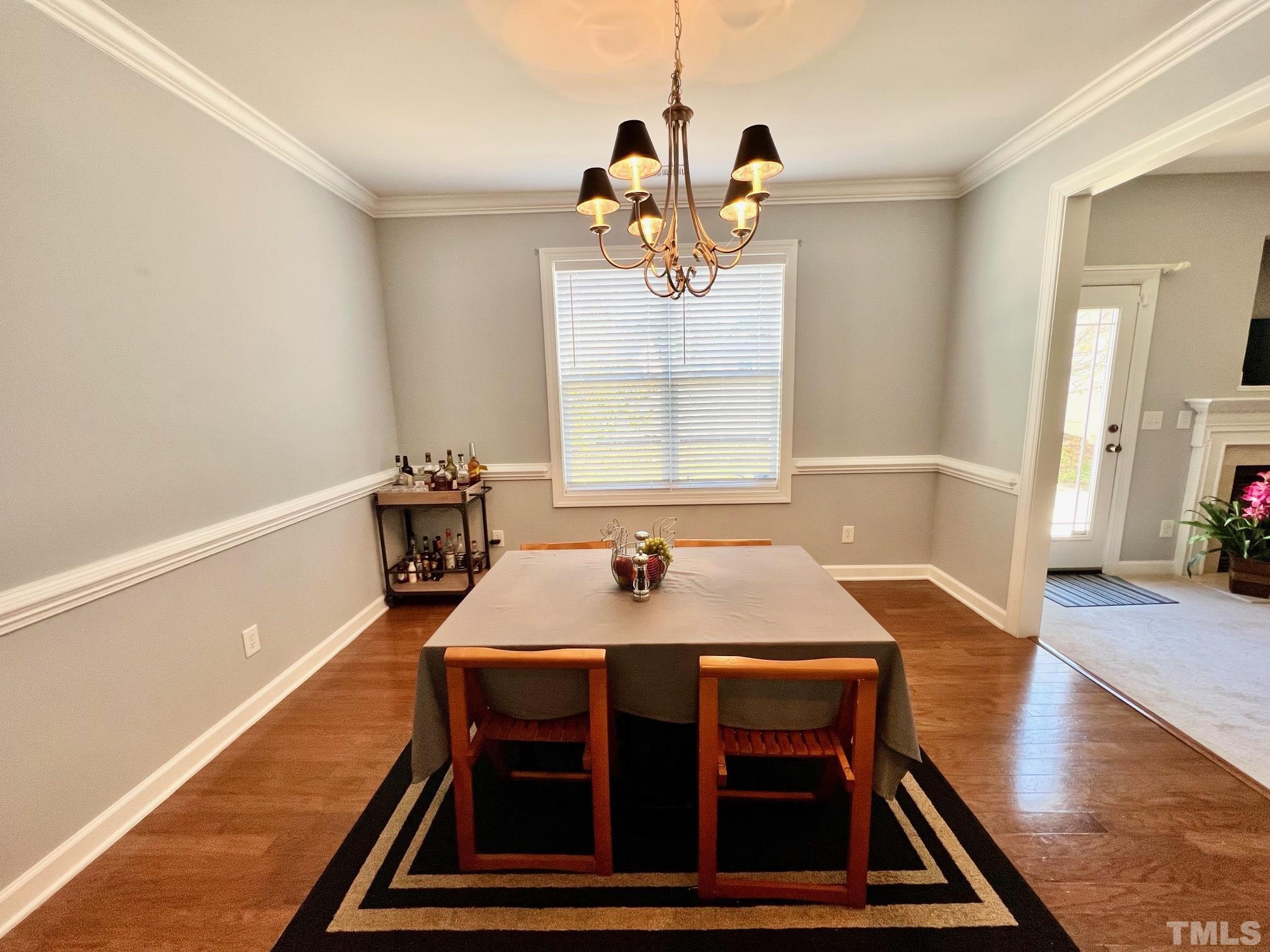 2231 Stoney Spring Drive Raleigh, NC 27610 - Photo 13 of 18 a view of a dining room with furniture window and wooden floor