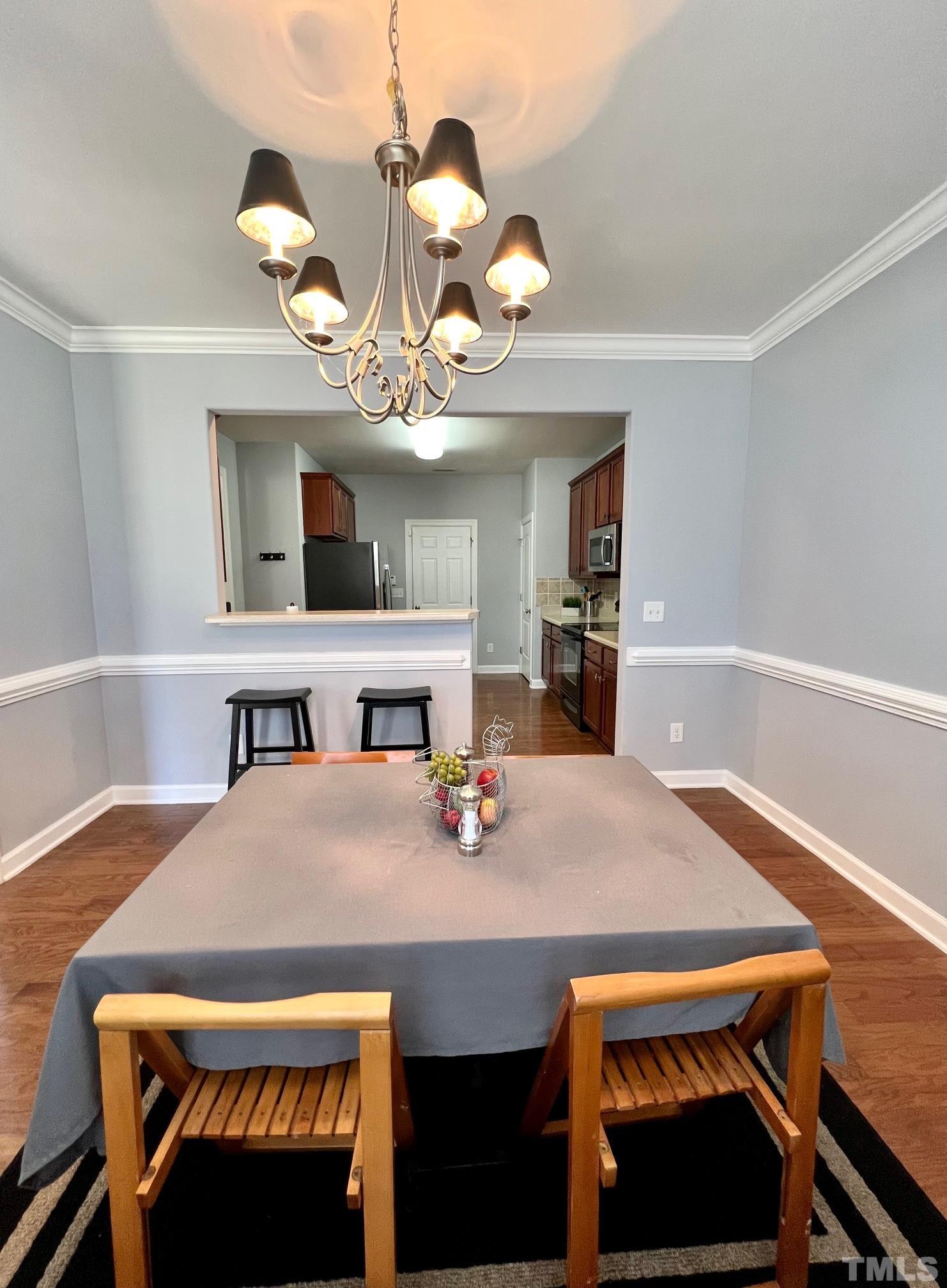 2231 Stoney Spring Drive Raleigh, NC 27610 - Photo 16 of 18 a view of a dining room with furniture and wooden floor