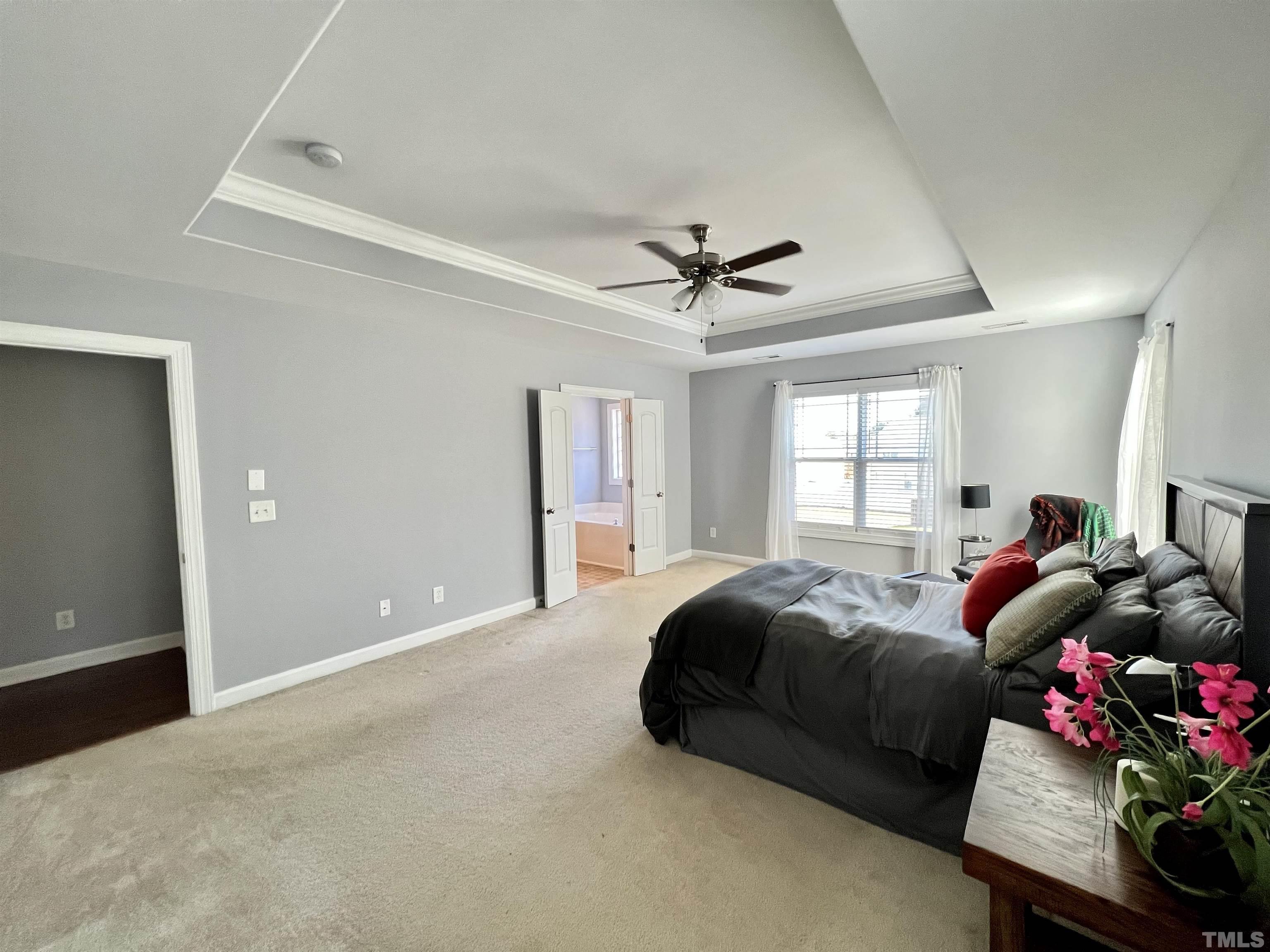 2231 Stoney Spring Drive Raleigh, NC 27610 - Photo 3 of 18 a living room with a bed and a chandelier