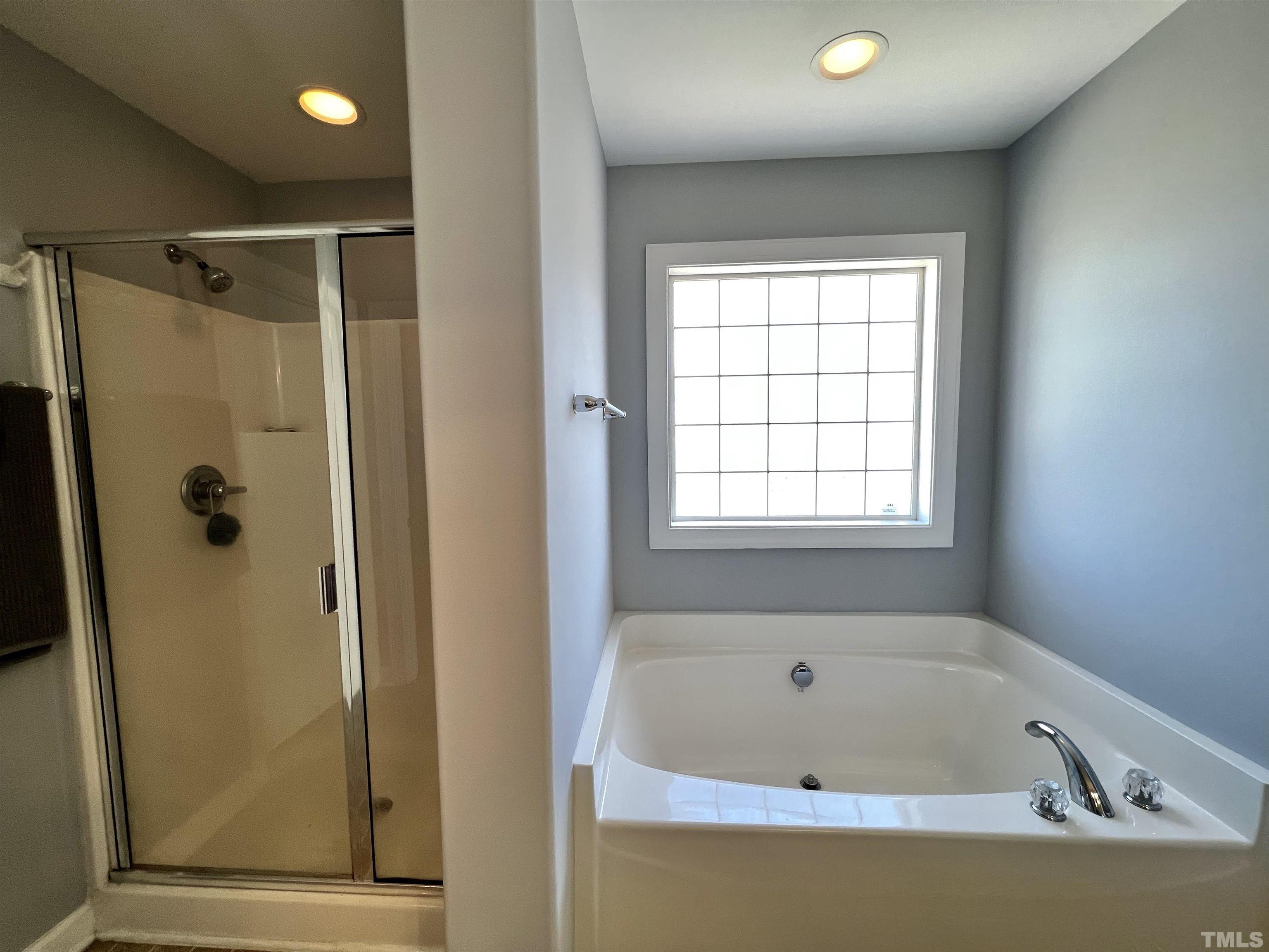2231 Stoney Spring Drive Raleigh, NC 27610 - Photo 7 of 18 a bathroom with a bathtub and a shower
