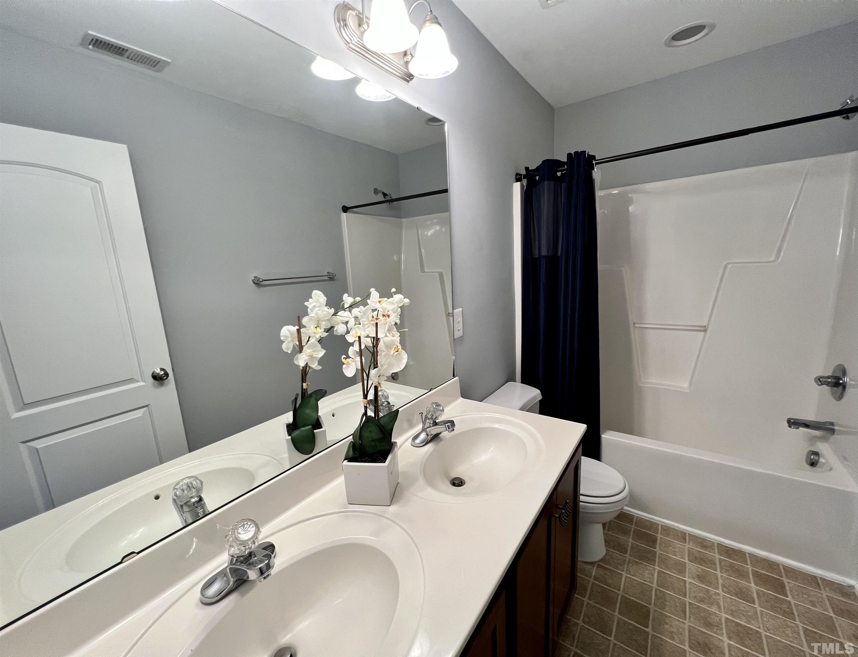 2231 Stoney Spring Drive Raleigh, NC 27610 - Photo 8 of 18 a bathroom with a tub sink and mirror