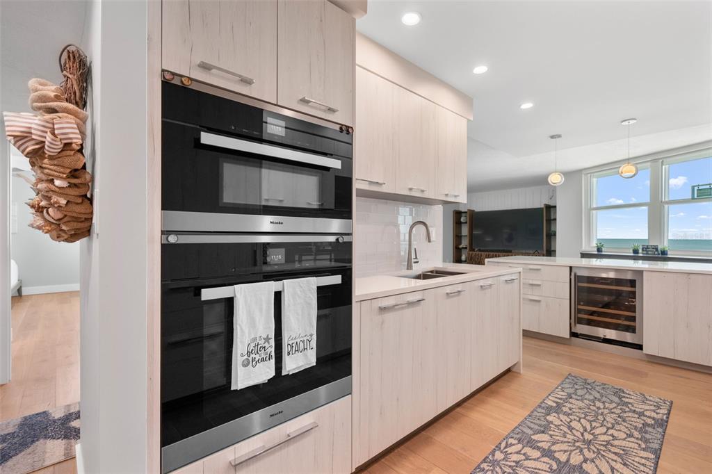 1050 Longboat Club Road, Unit 901 Longboat Key, FL 34228 - Photo 12 of 37 a kitchen with cabinets stainless steel appliances and counter space