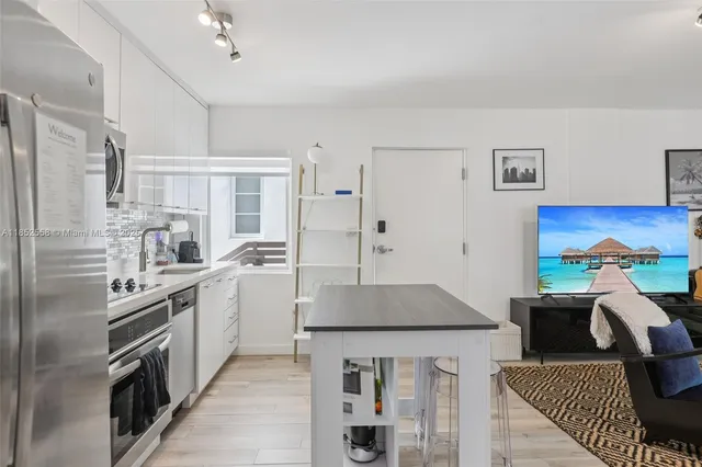 a kitchen with a sink stove and refrigerator