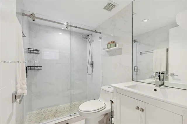 a bathroom with a sink a mirror and shower