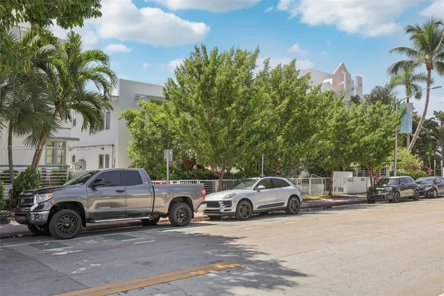a view of a cars park in front of a house