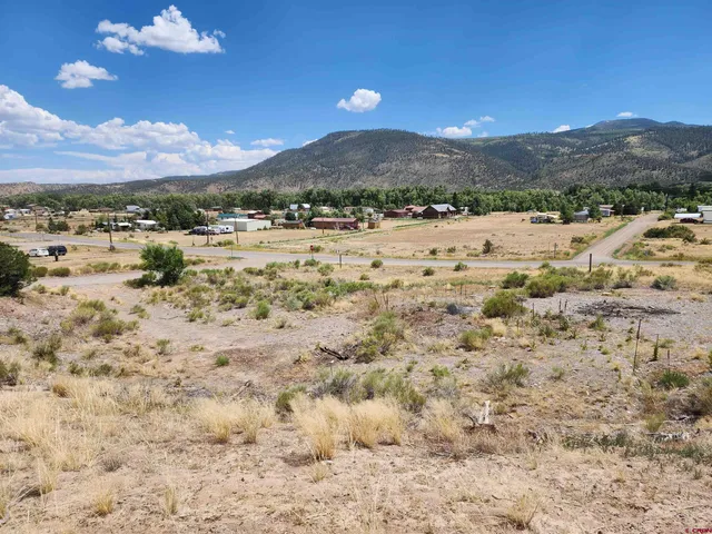 a view of a town with mountains in the background