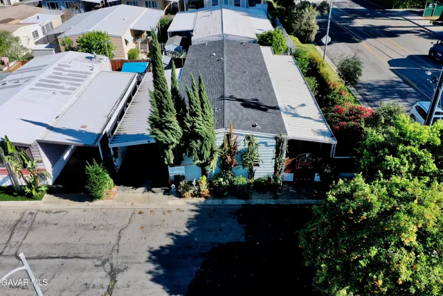 an aerial view of a house with a yard and garden