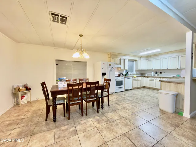 a large kitchen with a table and chairs