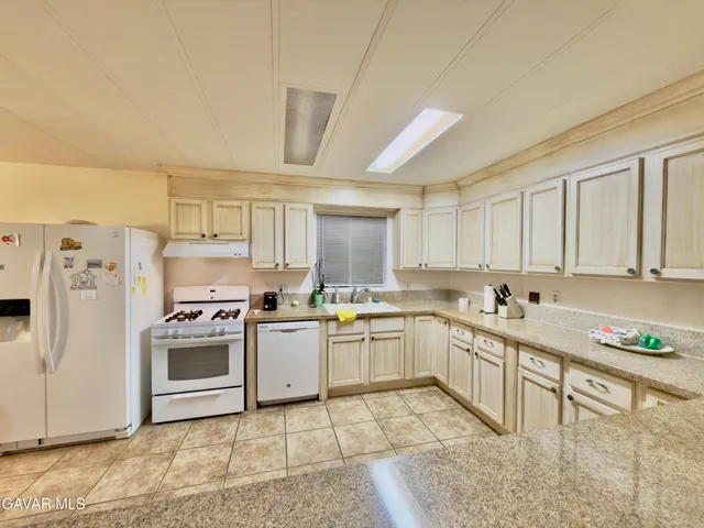 a kitchen with a sink stove and white cabinets