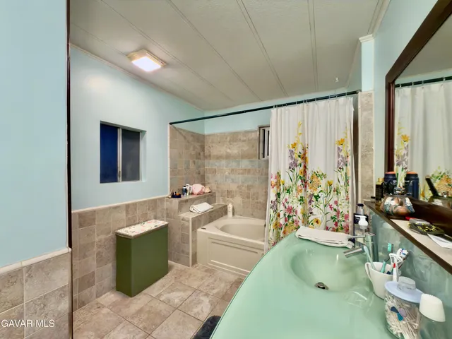 a bathroom with a bathtub a sink and a shower