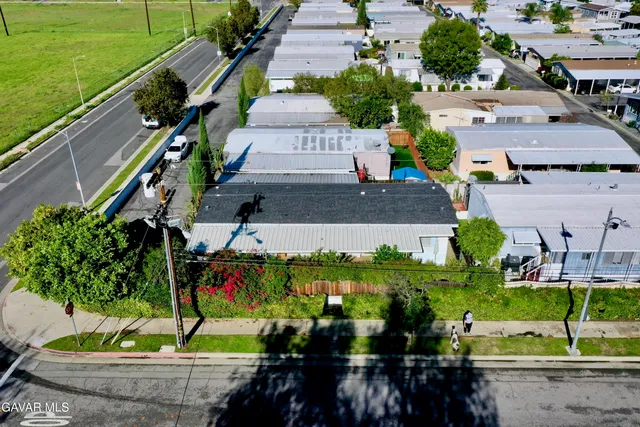 an aerial view of multiple houses with yard