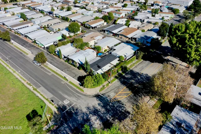 an aerial view of residential houses with outdoor space