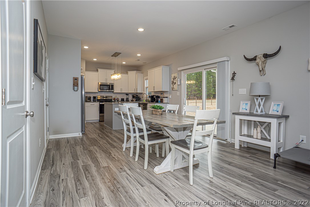 2426 Calloway Road Raeford, NC 28376 - Photo 17 of 50 a view of a dining room with furniture window and wooden floor