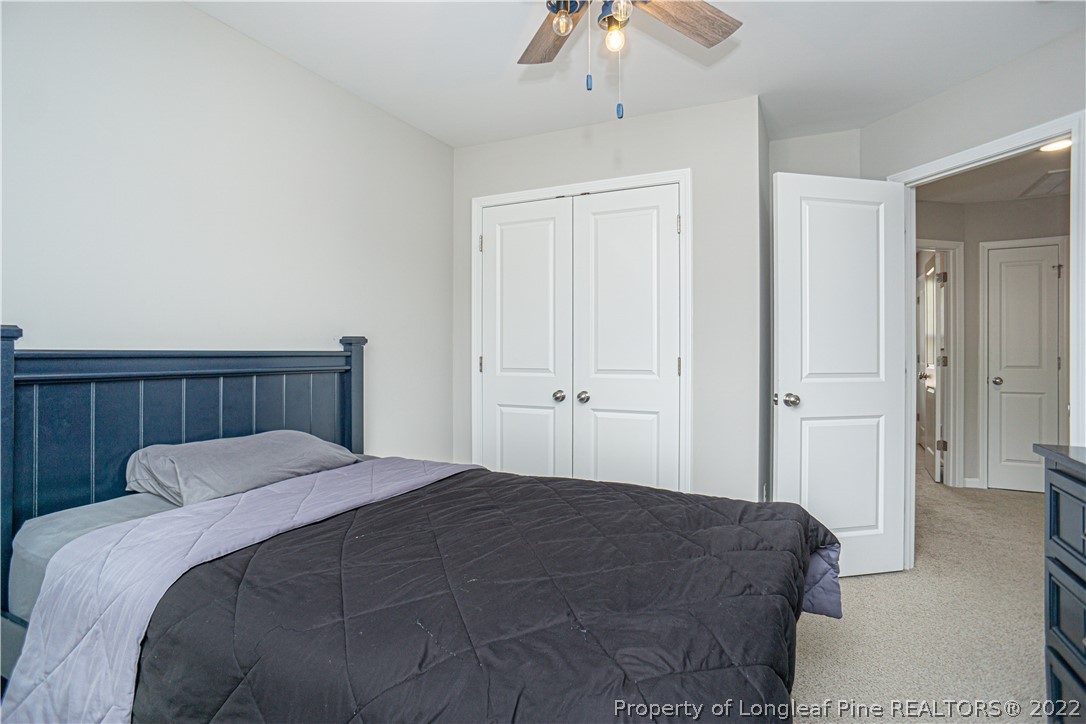2426 Calloway Road Raeford, NC 28376 - Photo 46 of 50 a bedroom with a bed and a chandelier