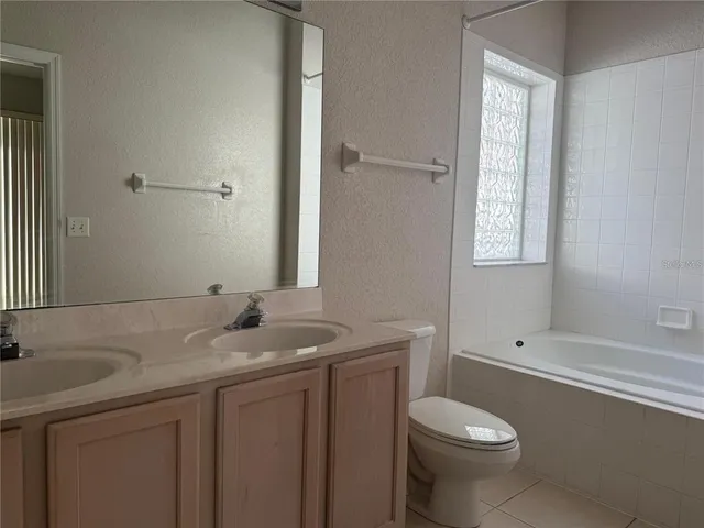 a view of a kitchen with fridge and a stove top oven