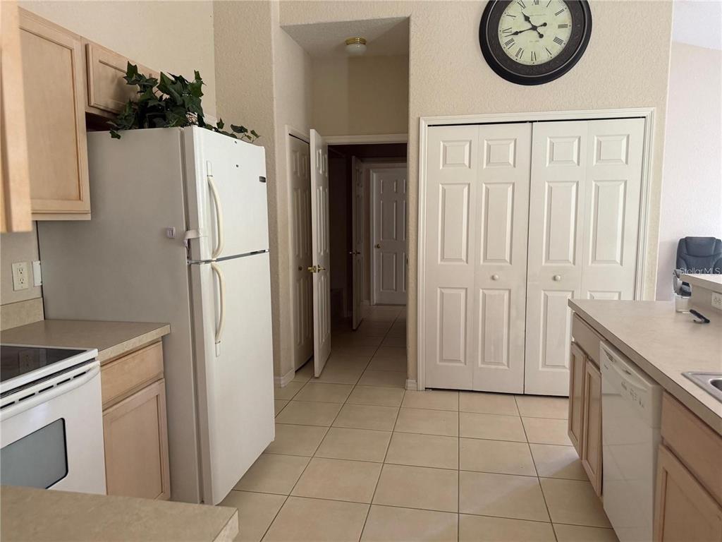 525 Corvina Drive Davenport, FL 33897 - Photo 9 of 15 a view of a kitchen with fridge and a stove top oven