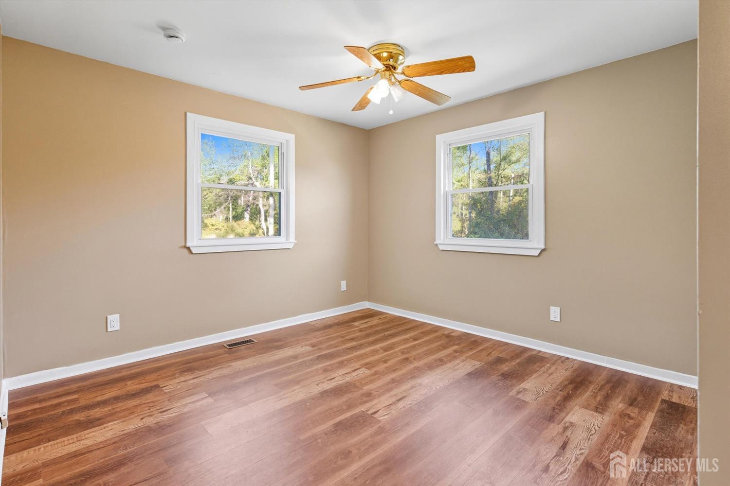 2092 Main Road Newfield, NJ 08344 - Photo 13 of 29 a view of an empty room with a window and wooden floor
