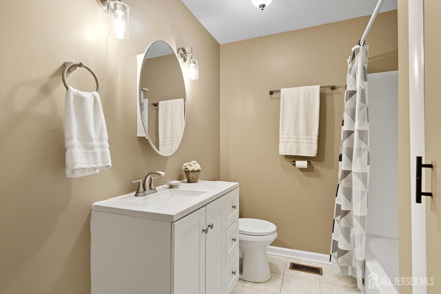 2092 Main Road Newfield, NJ 08344 - Photo 15 of 29 a bathroom with a toilet sink and mirror
