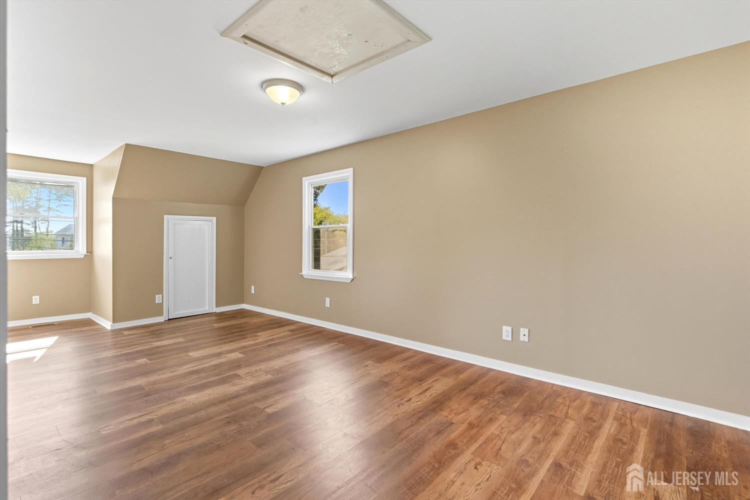 2092 Main Road Newfield, NJ 08344 - Photo 16 of 29 an empty room with wooden floor and windows