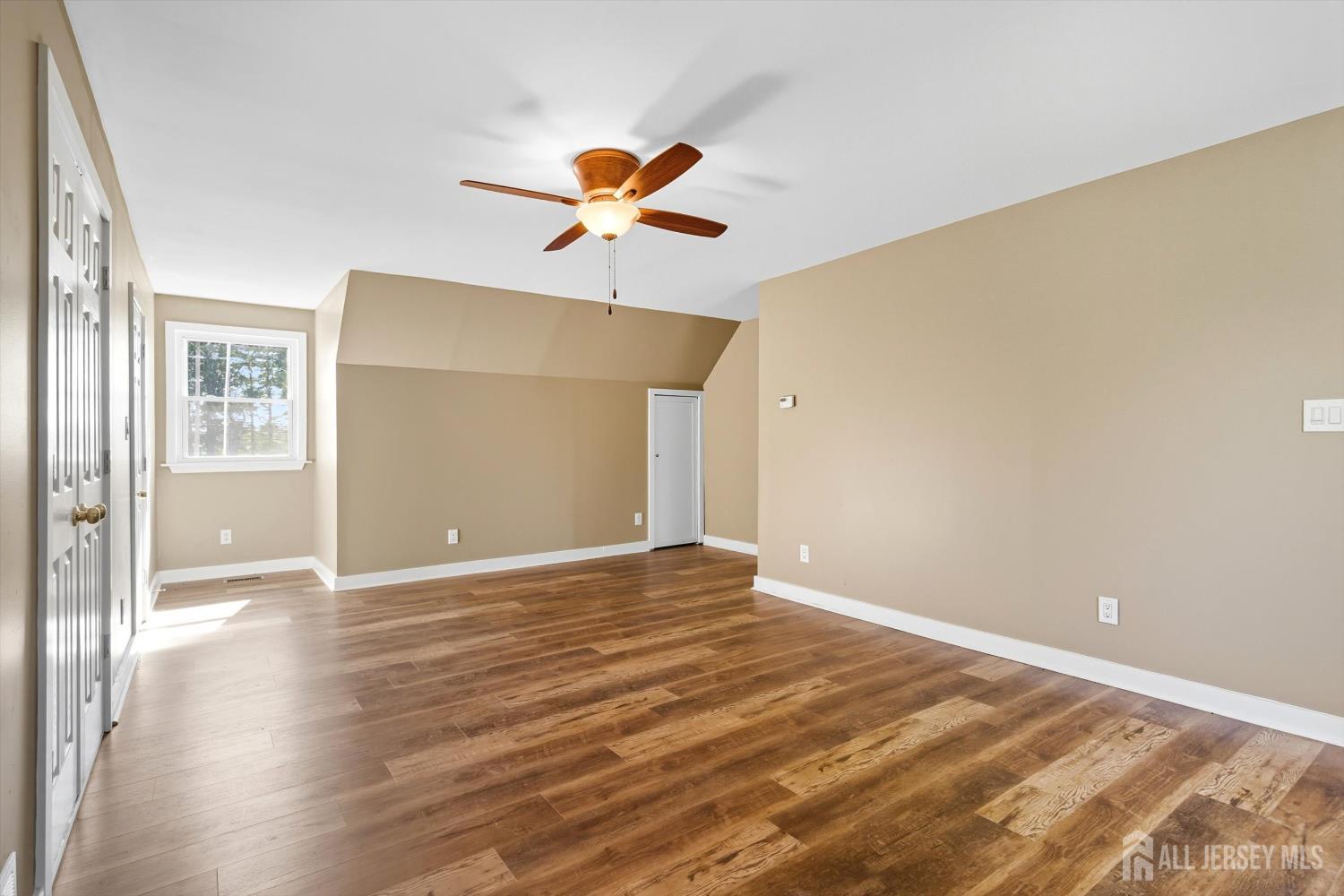 2092 Main Road Newfield, NJ 08344 - Photo 18 of 29 a view of a big room with wooden floor and a ceiling fan