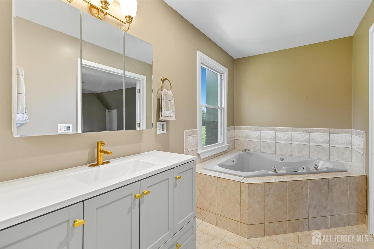 2092 Main Road Newfield, NJ 08344 - Photo 22 of 29 a bathroom with a bathtub sink and mirror
