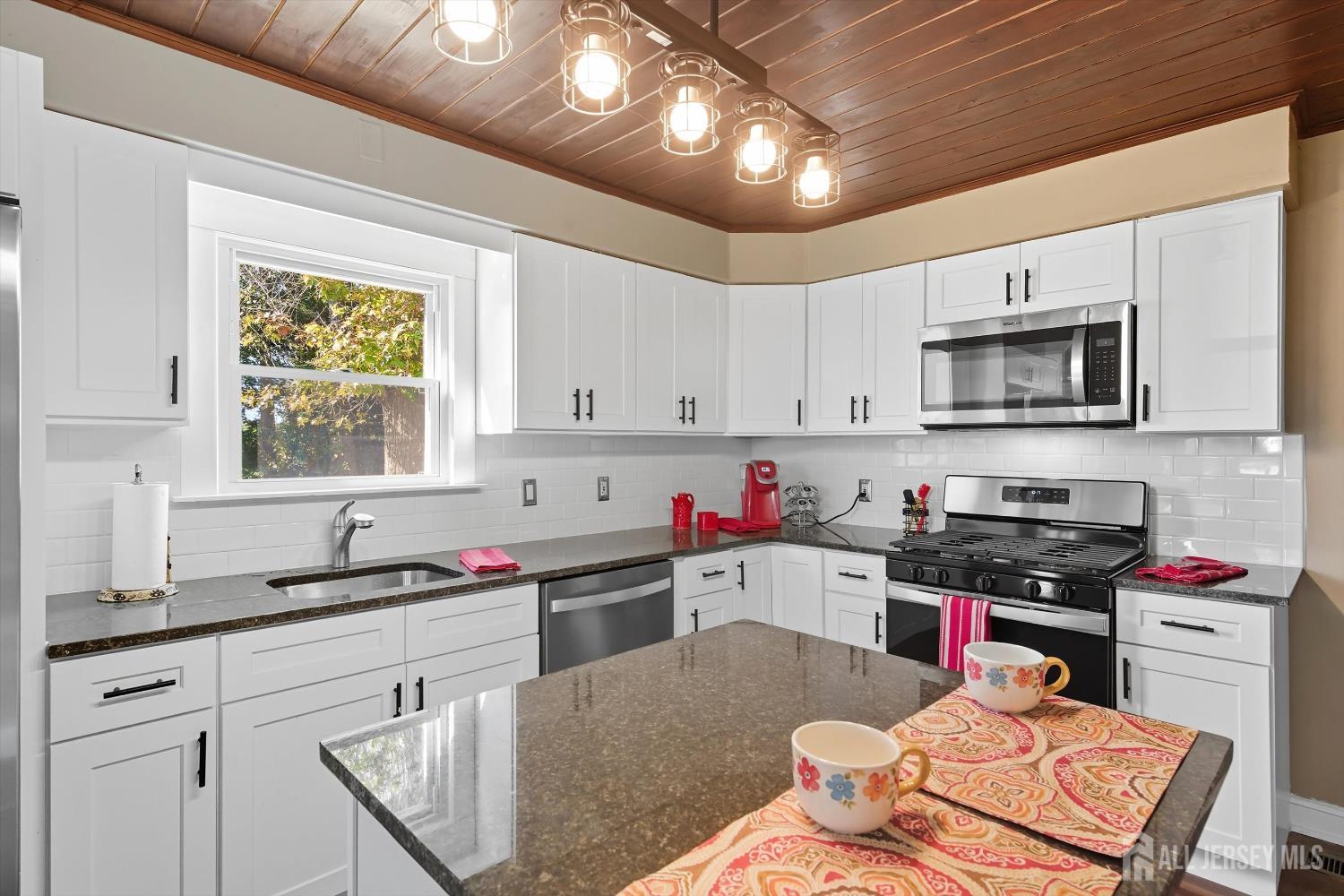 2092 Main Road Newfield, NJ 08344 - Photo 9 of 29 a kitchen with granite countertop a sink cabinets and window