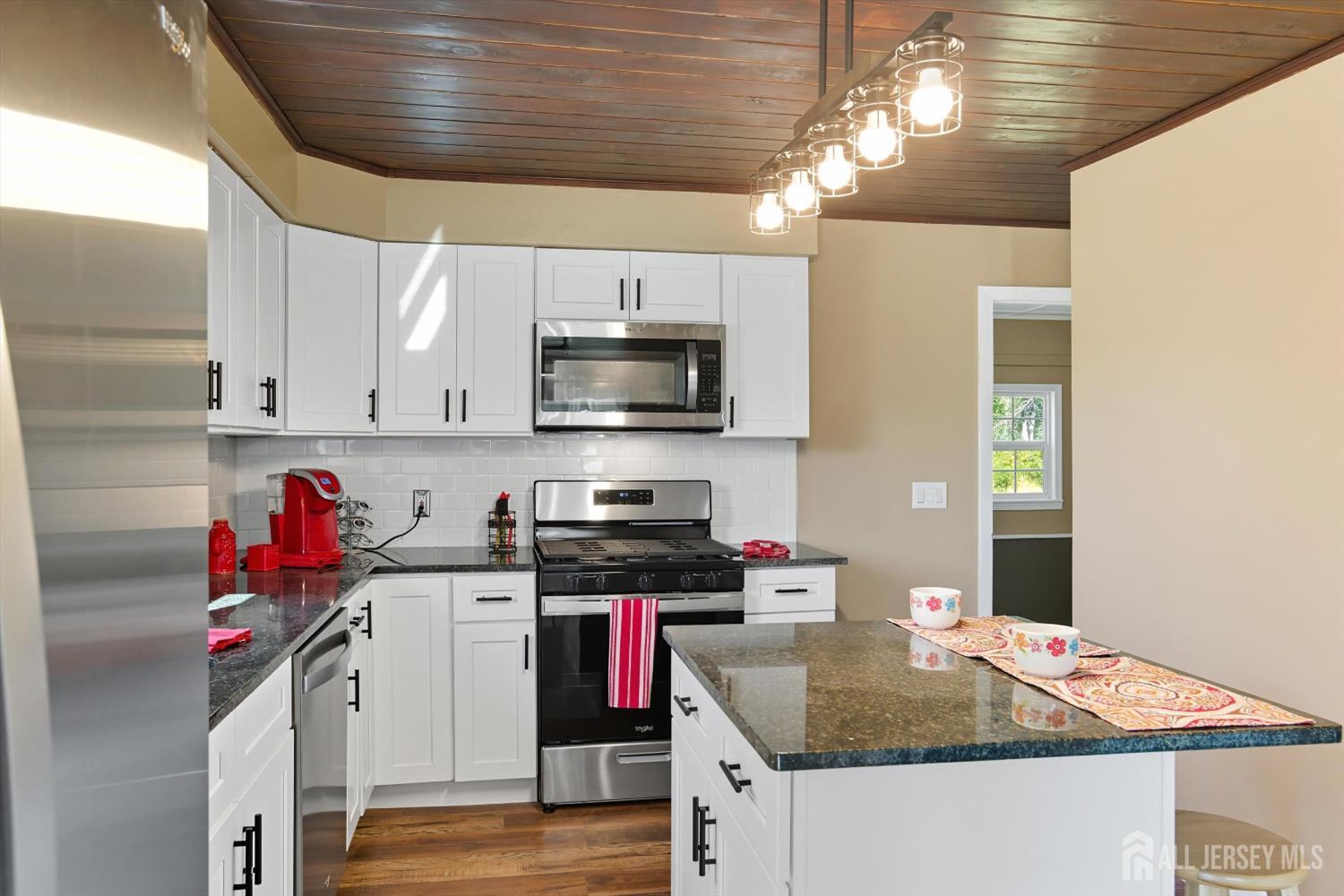 2092 Main Road Newfield, NJ 08344 - Photo 10 of 29 a kitchen that has a microwave a stove and white cabinets