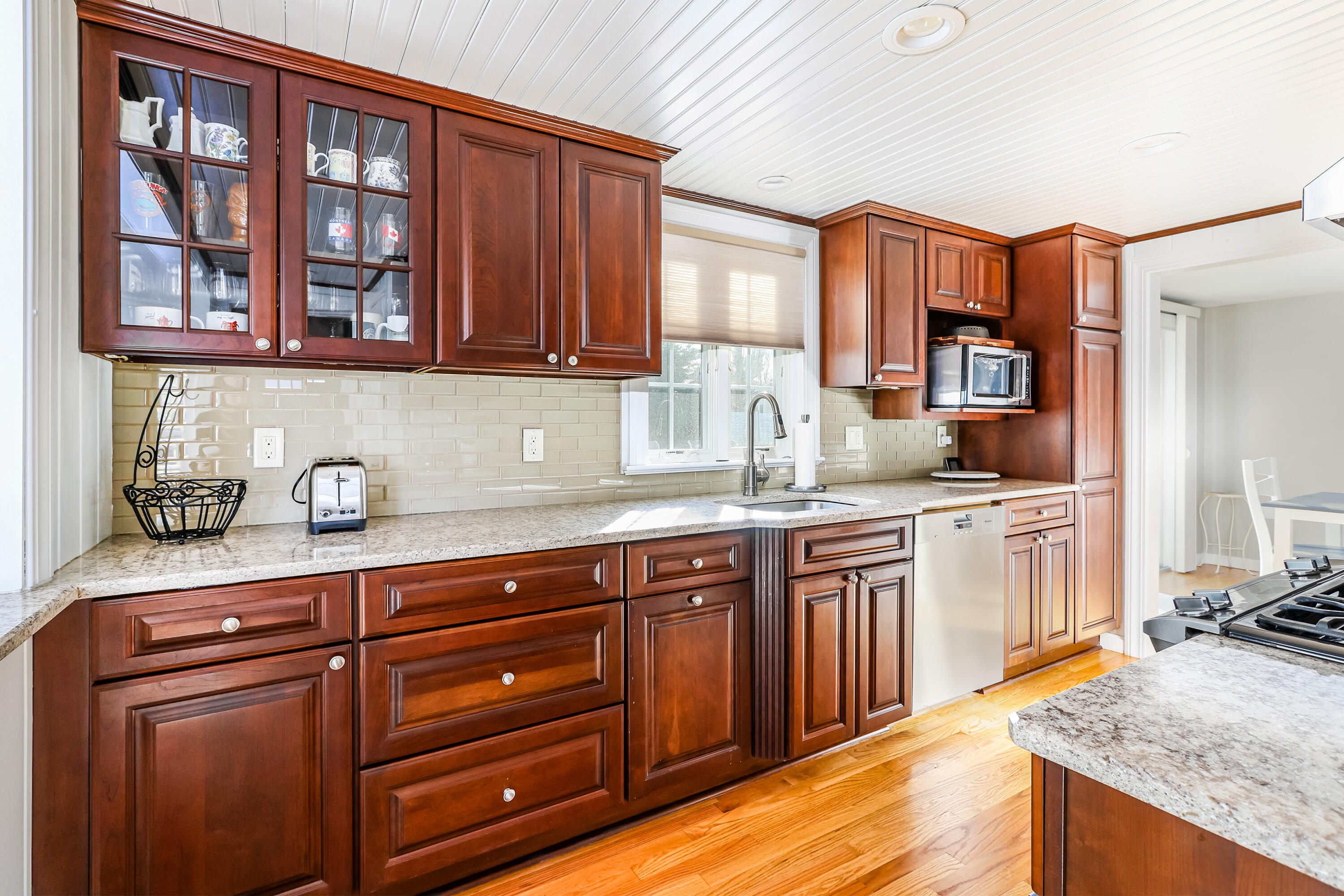 15 Captain Small Road South Yarmouth, MA 02664 - Photo 6 of 22 a kitchen with granite countertop wooden cabinets and white appliances