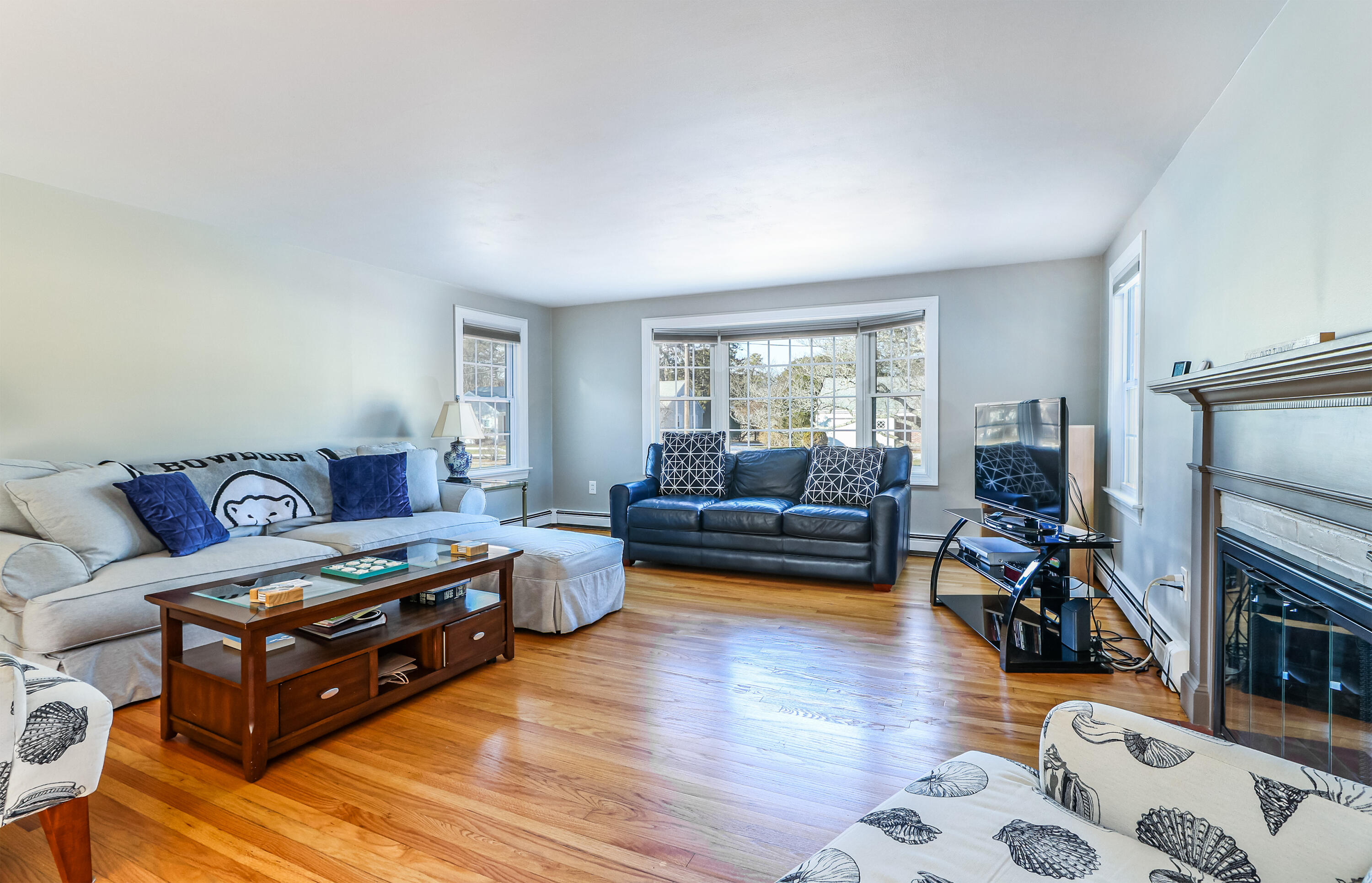15 Captain Small Road South Yarmouth, MA 02664 - Photo 10 of 22 a living room with furniture and a fireplace