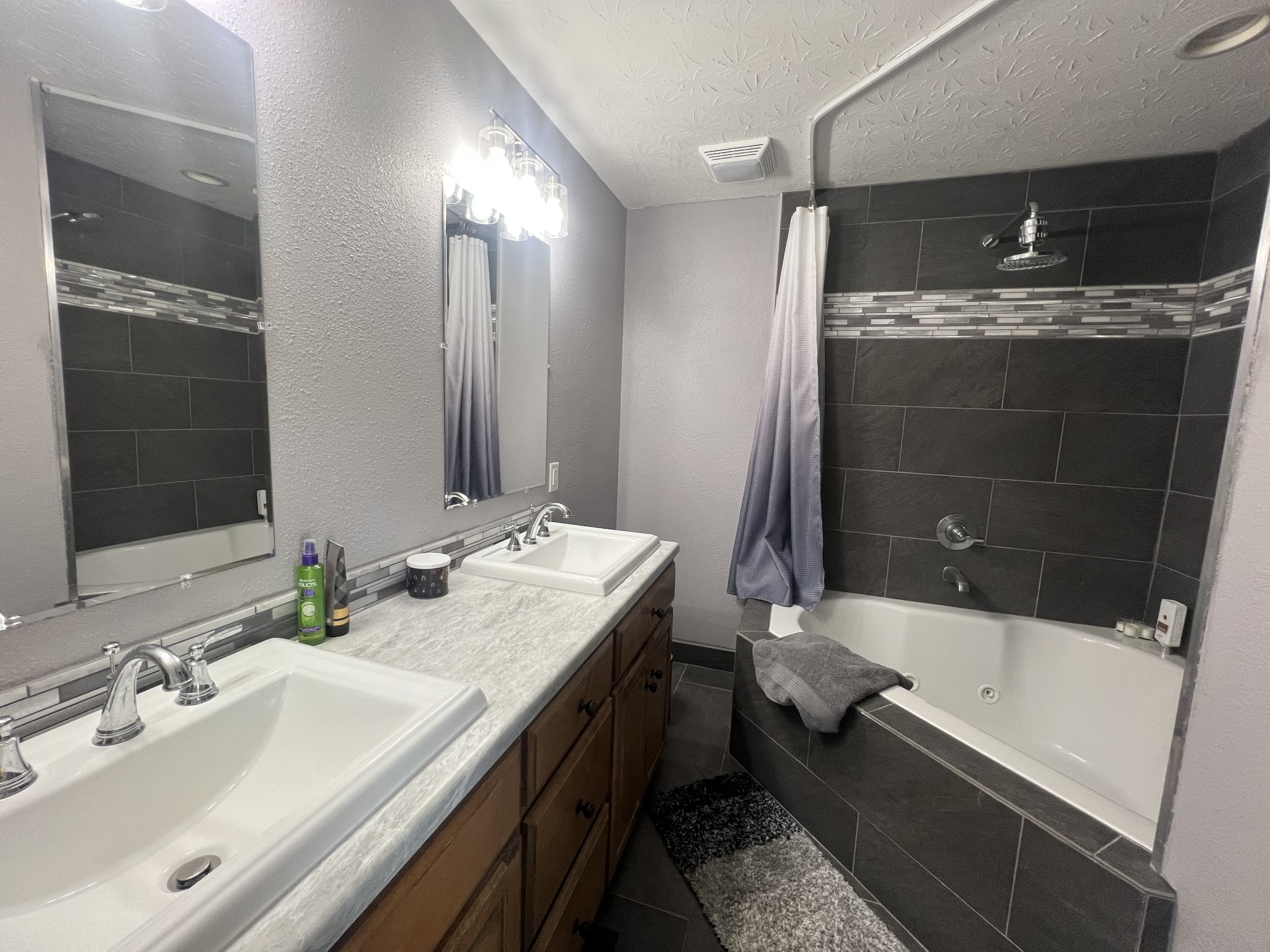 9516 Bakerton Road Red Boiling Springs, TN 37150 - Photo 31 of 60 a bathroom with a double vanity sink and mirror with bathtub