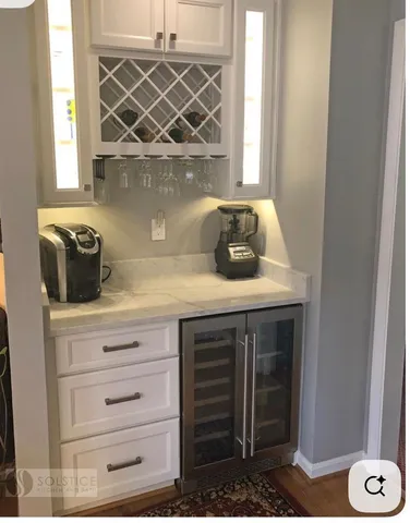 a view of a swimming pool with a chairs and table in the patio