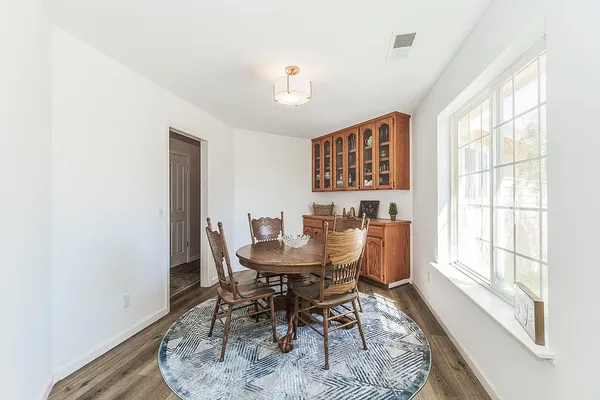 a dining room with furniture and wooden floor