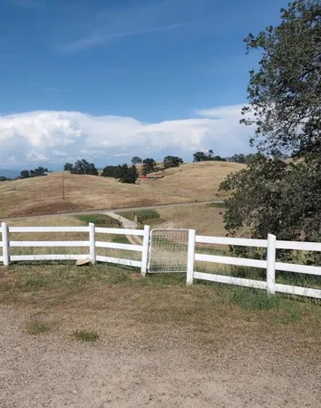 a kitchen with a refrigerator a stove top oven a sink dishwasher and wooden cabinets with wooden floor