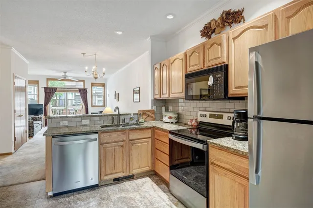 a kitchen with stainless steel appliances a stove sink microwave and refrigerator