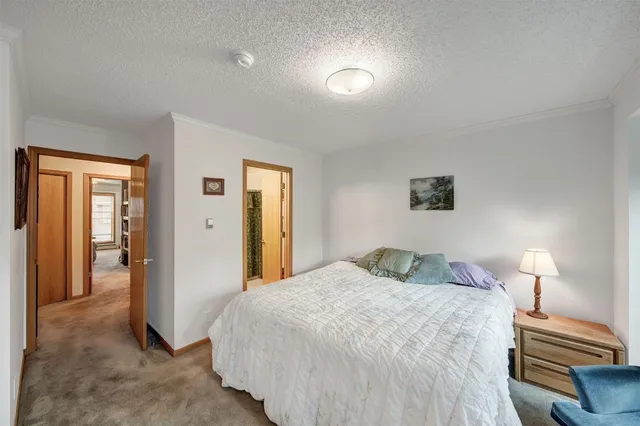 a bedroom with a bed and a lamp