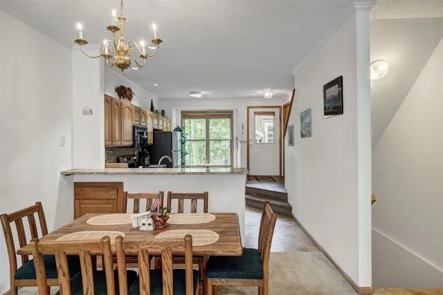 a view of a dining room with furniture and a chandelier