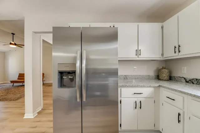 a spacious bathroom with a double vanity sink a toilet and a mirror