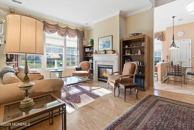 a living room with furniture a large window and a fireplace