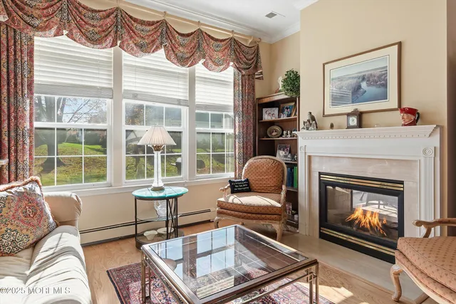 a living room with furniture a window and a fireplace