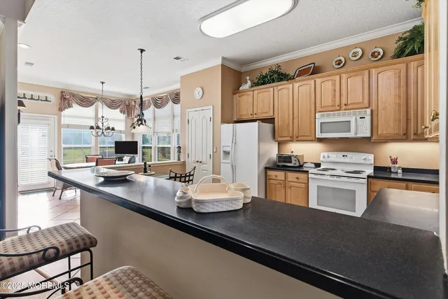 a kitchen with kitchen island a sink stove and refrigerator