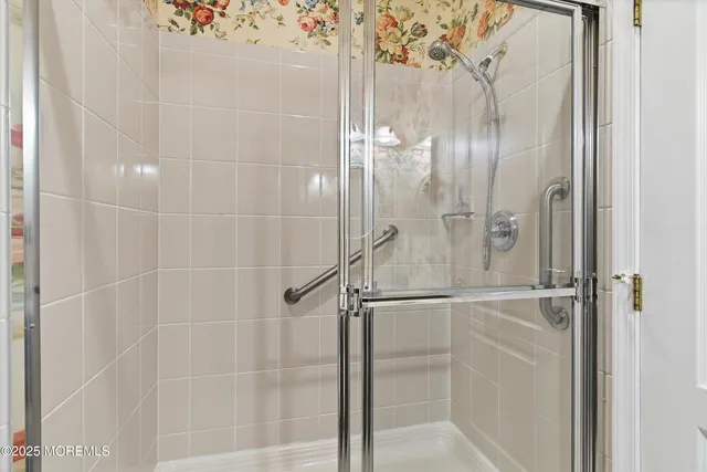 a bathroom with a glass shower door