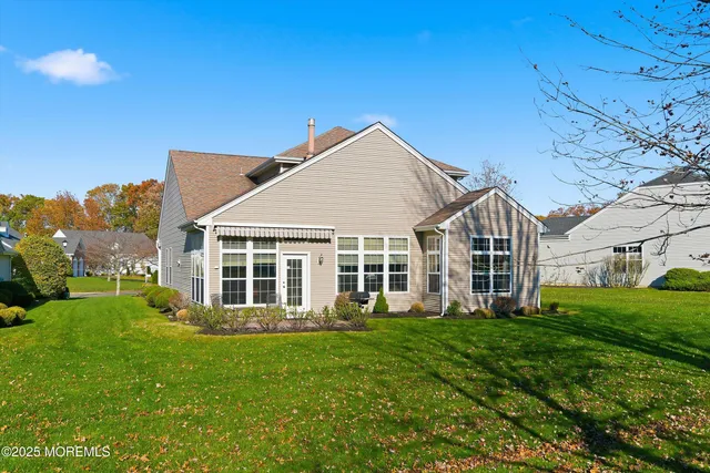 a view of a house with a backyard
