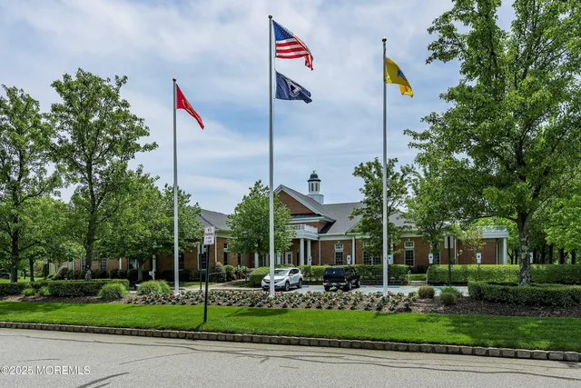 a front view of a house with a yard and a fountain