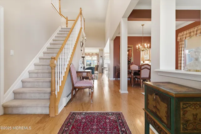 a view of entryway and hall with wooden floor