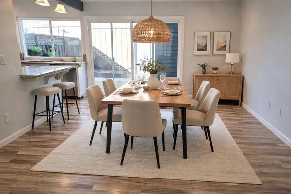a view of a dining room with furniture window and wooden floor