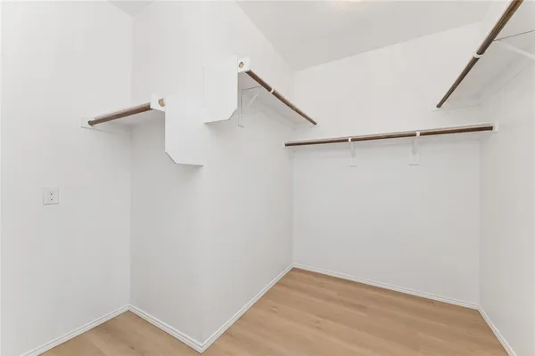 a bathroom with a sink mirror and shower