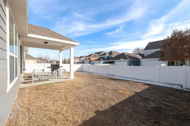 a view of a house with a backyard and a porch